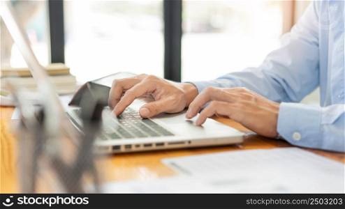 Business analyst concept the hands of businessman inserting the information of the products by using laptop.