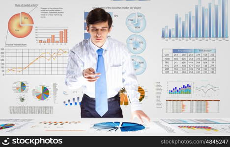 Business analytics. Young businessman analyzing data information of market