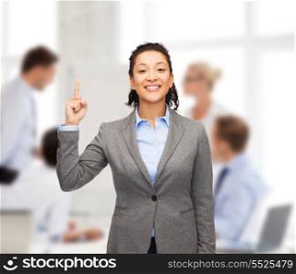 business and advertisement concept - attractive young woman with her finger up at office