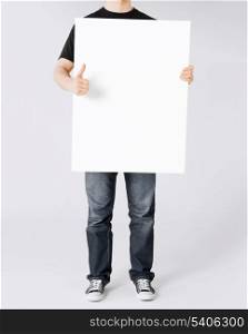 business and advertisement concept - man showing white blank board and thumbs up