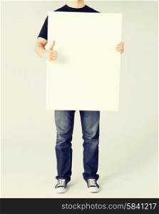 business and advertisement concept - man showing white blank board and thumbs up