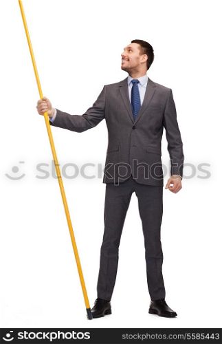 business and advertisement concept - smiling businessman holding flagpole with imaginary flag