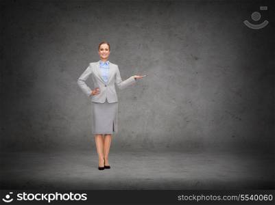 business and advertisement concept - smiling businesswoman showing something on palm of her hand