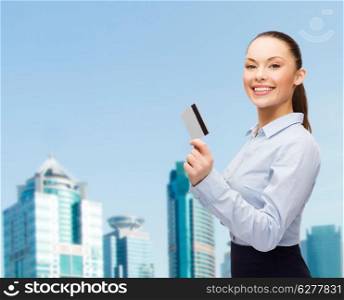 business and bank concept - smiling businesswoman showing credit card
