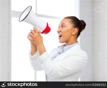 business and communication, bad boss concept - strict businesswoman shouting in megaphone in office