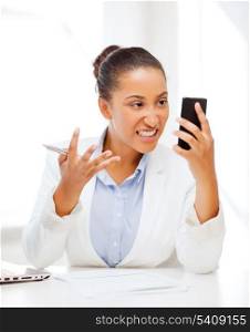 business, and communication concept - african woman shouting into smartphone