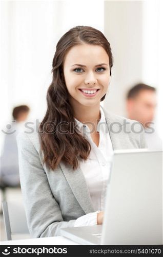 business and communication concept - businesswoman with laptop computer at work