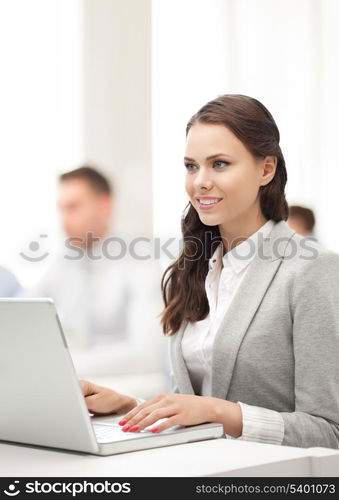 business and communication concept - businesswoman with laptop computer at work