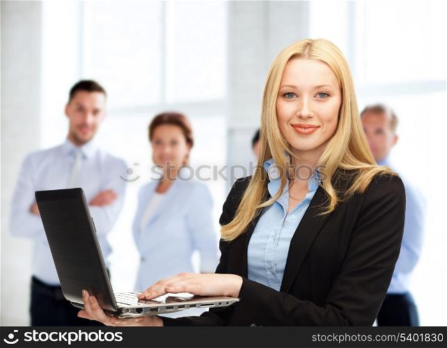 business and communication concept - businesswoman with laptop computer at work