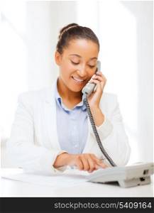 business, and communication concept - smiling african businesswoman with phone in office