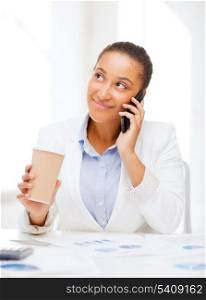 business, and communication concept - smiling african businesswoman with smartphone in office