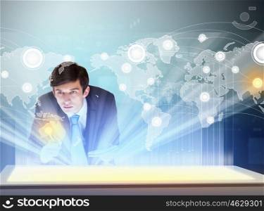 Business and communication innovations. Image of young businessman clicking icon on high-tech picture