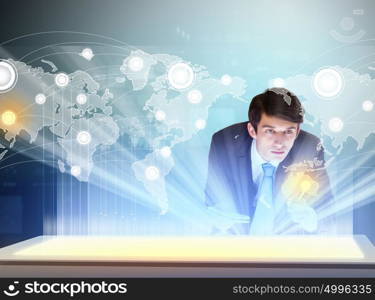 Business and communication innovations. Image of young businessman clicking icon on high-tech picture