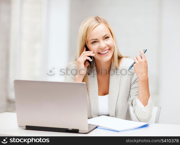 business and communication - smiling businesswoman with smartphone in office