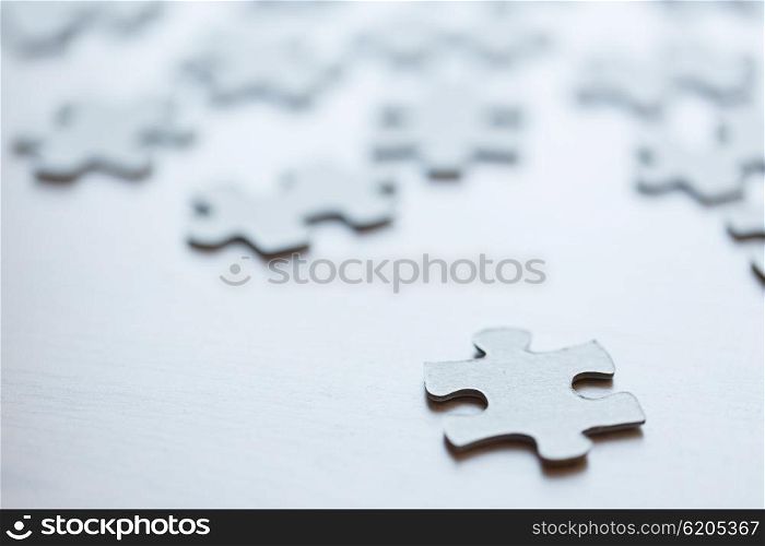 business and connection concept - close up of puzzle pieces on table. close up of puzzle pieces on table