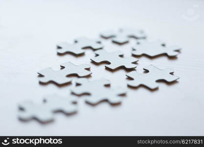 business and connection concept - close up of puzzle pieces on table. close up of puzzle pieces on table