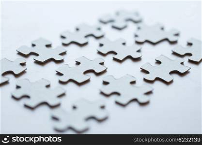 business and connection concept - close up of puzzle pieces on table. close up of puzzle pieces on table