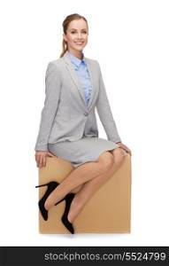 business and delivery service concept - smiling woman sitting on cardboard box