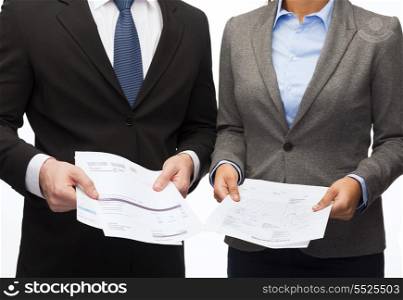 business and economy concept - smiling businesswoman and businessman with files and forms
