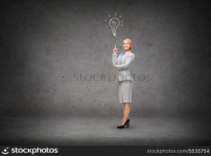 business and education concept - attractive young businesswoman with her finger up and light bulb