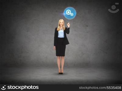 business and education concept - attractive young businesswoman with her finger up and setting icon