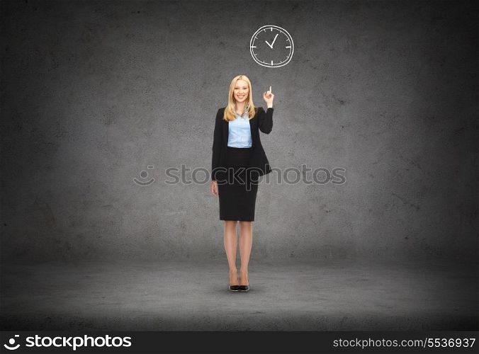 business and education concept - attractive young businesswoman with her finger up and wall clock