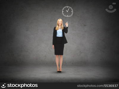 business and education concept - attractive young businesswoman with her finger up and wall clock