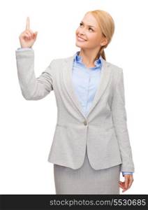 business and education concept - attractive young businesswoman with her finger up looking up