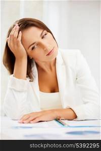 business and education concept - bored and tired woman with documents