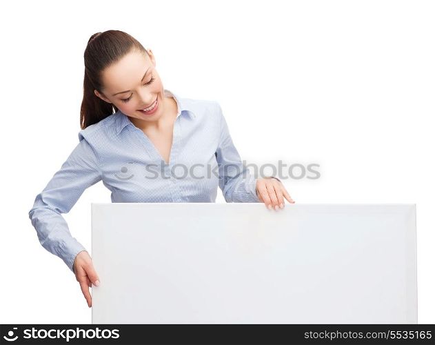 business and education concept - friendly young smiling businesswoman looking at white blank board