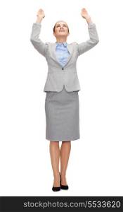 business and education concept - friendly young smiling businesswoman pushing up something imaginary