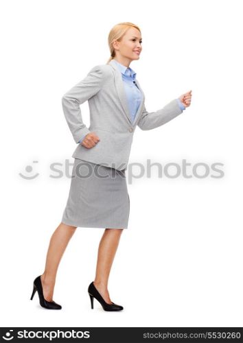 business and education concept - friendly young smiling businesswoman running