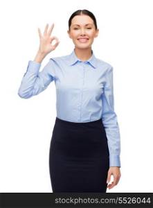 business and education concept - friendly young smiling businesswoman showing ok sign