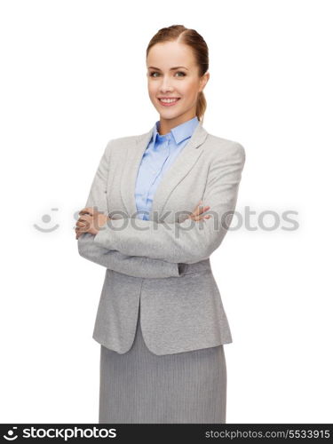 business and education concept - friendly young smiling businesswoman with crossed arms