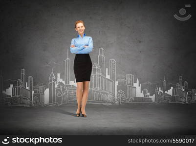 business and education concept - friendly young smiling businesswoman with crossed arms