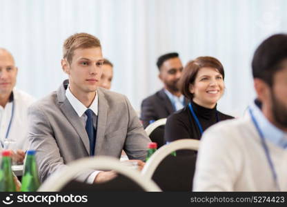 business and education concept - group of happy people at international conference. happy business team at international conference