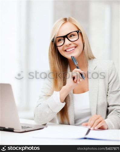 business and education concept - indoor picture of smiling woman with documents and pen