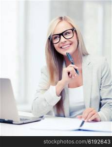 business and education concept - indoor picture of smiling woman with documents and pen. businesswoman with documents