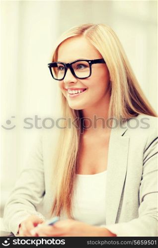 business and education concept - indoor picture of smiling woman with eyeglasses