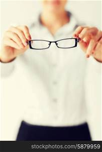 business and education concept - indoor picture of woman with eyeglasses