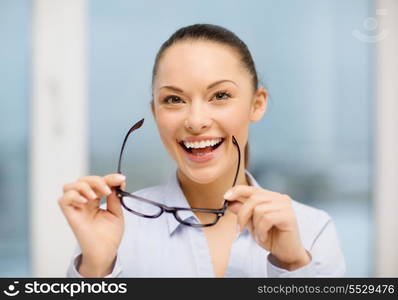 business and education concept - laughing businesswoman with eyeglasses