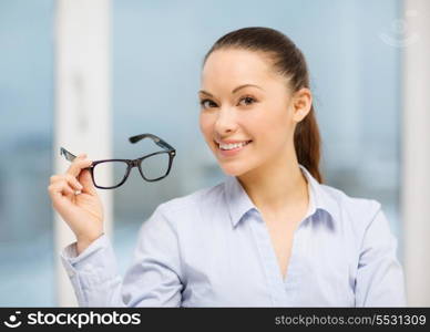 business and education concept - laughing businesswoman with eyeglasses