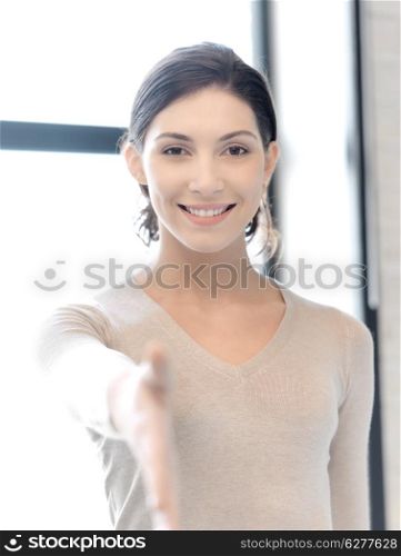 business and education concept - lovely woman with an open hand ready for handshake