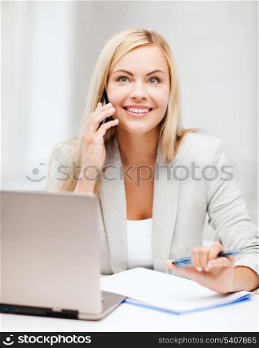 business and education concept - picture of businesswoman with laptop and cell phone