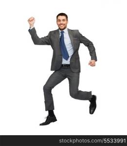 business and education concept - smiling businessman jumping