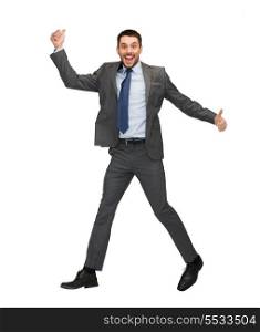 business and education concept - smiling businessman jumping and showing thumbs up