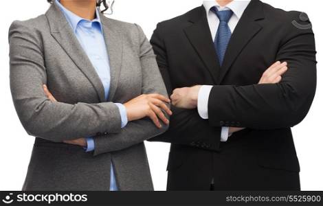 business and education concept - smiling businesswoman and businessman with crossed arms