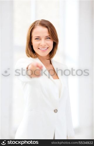 business and education concept - smiling businesswoman pointing finger at you