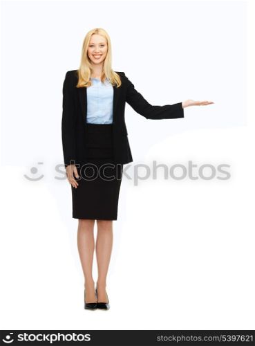 business and education - woman showing something imaginary on her hand