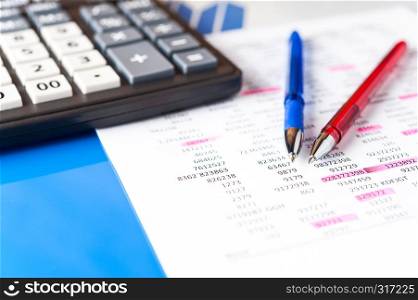 Business and financial background with charts, pen and calculator. Economy trends background for business idea and all art work design. Abstract bookkeeping background.. Business and financial background with data, pen and calculator. Bookkeeping background.